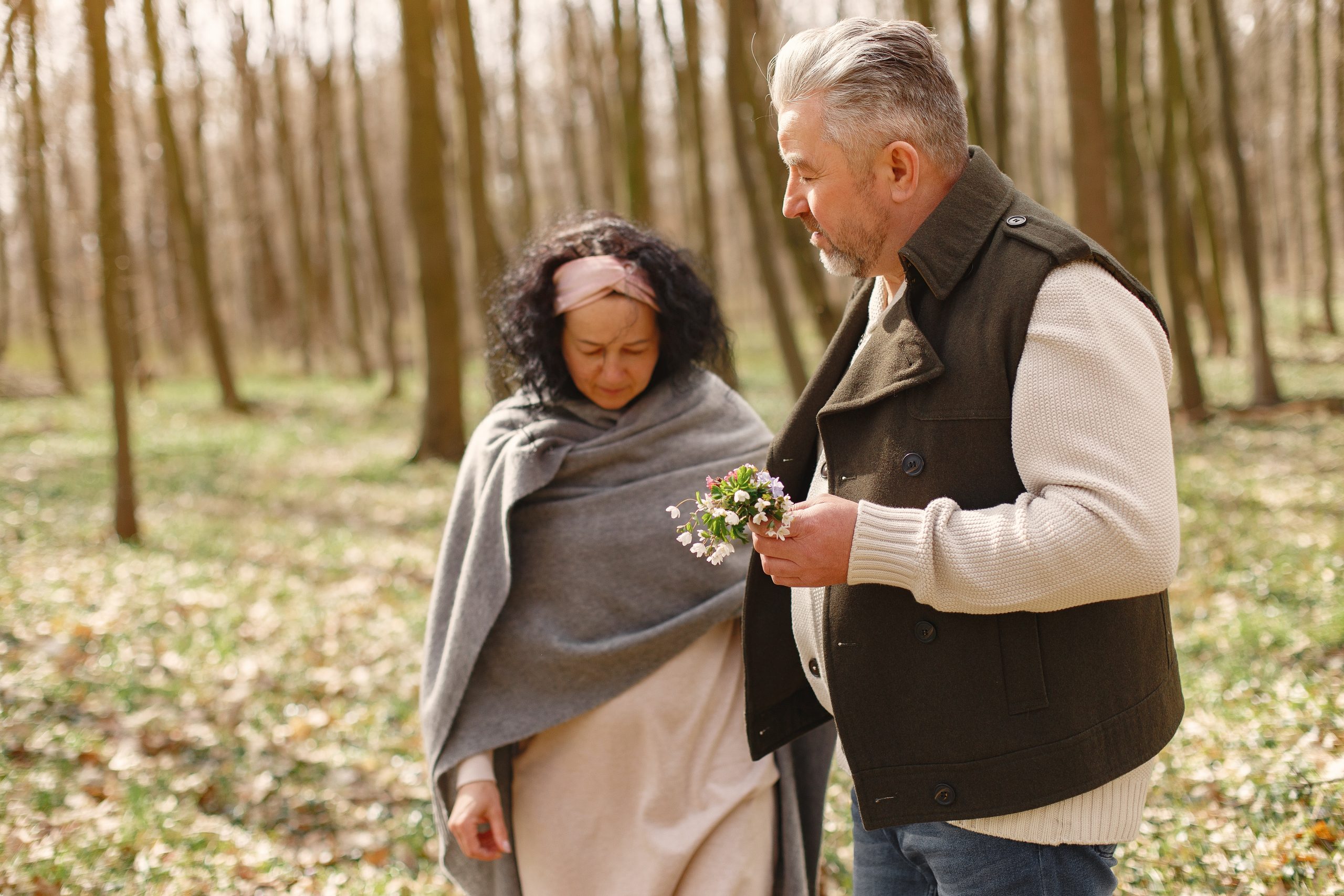 Elegant adult couple in a spring forest